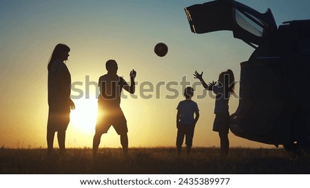 family traveling by car. family watching the sunset silhouette lifestyle next to the car in park. family playing ball. people in the park. family car camping resting in nature