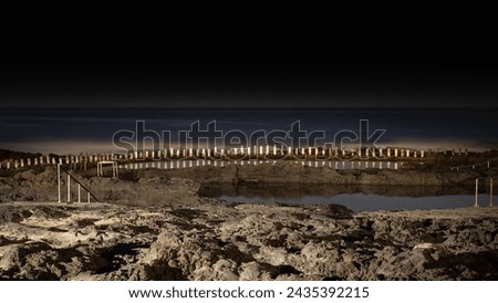 Natural sea water swimming pools of Agaete, Puerto de las nieves in Gran Canaria, Spain. Night time long exposure with no visible people and sea horizon Royalty-Free Stock Photo #2435392215