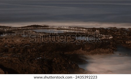 Natural sea water swimming pools of Agaete, Puerto de las nieves in Gran Canaria, Spain. Night time long exposure with no visible people Royalty-Free Stock Photo #2435392223
