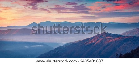 Long focus picture of misty rolling hills in Carpathian mountains. Splendid autumn sunrise on mountain woodland, Transcarpathian, Ukraine, Europe. Beauty of nature concept background.
