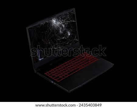 open laptop on broken screen isolated on black background