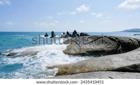 Coastal cliffs with large ocean waves hitting the rocks. Peninsula, Thailand.