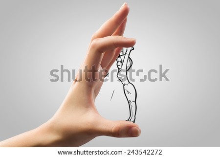 Human hand and funny caricature of businesswoman