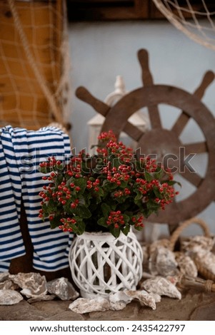 Decor in the maritime theme, anchor, glass bowls, shells and ropes. Party decorations.