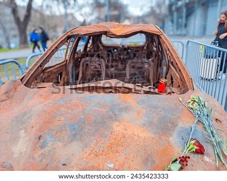 burned-out civilian car. War in Ukraine. Russian invasion of Ukraine. War crimes Royalty-Free Stock Photo #2435423333