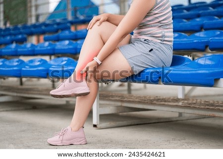 Achilles tendon injury, callus on the heel while running, foot pain, woman suffering from feet ache on a sports ground, podiatry concept Royalty-Free Stock Photo #2435424621