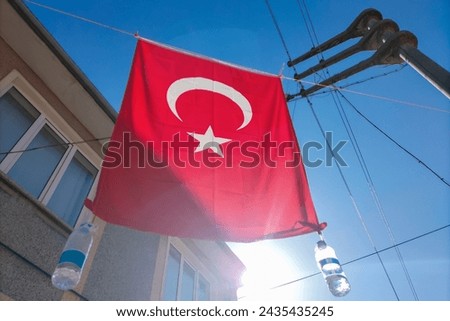 The tradition of hanging the Turkish national flag on the street during festive events, such as weddings, public holidays. Royalty-Free Stock Photo #2435435245