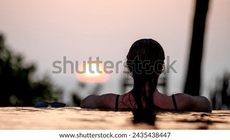girl in the pool at dawn by the sea in