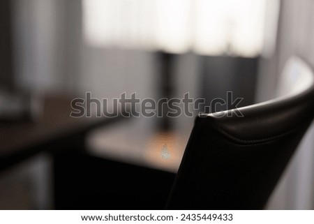 Blurred background of dining room with leather chair closeup Royalty-Free Stock Photo #2435449433