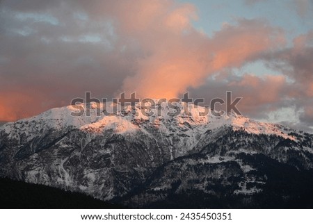 Orange sunset over the snow of the Himalayan mountains