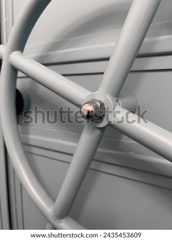 Metal knob to open the hatch on a ship, opening the door on warships, closed hatch, no passage, no entry allowed, interior of a warship, Metal knob, Hatch, Ship, Warship, Door, Closed hatch, No pass Royalty-Free Stock Photo #2435453609