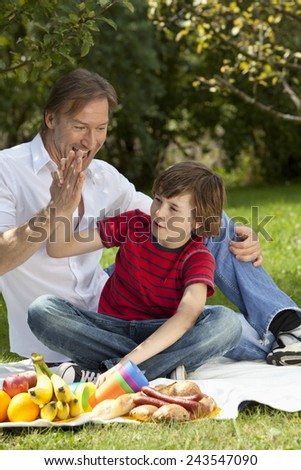 Germany, Bavaria, Father and son having fun at picnic