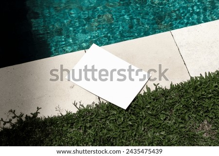 Poster mockup template, real photo, set amidst the pool environment. Blank isolated object to place your design. 
