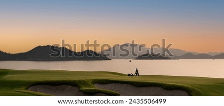 Beautiful picture of a beach golf hole in the early morning with magnificent view of the ocean and mountain landscape in behind
