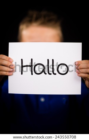 Studio shot of child holding a sign with German word Hallo - Hello in English