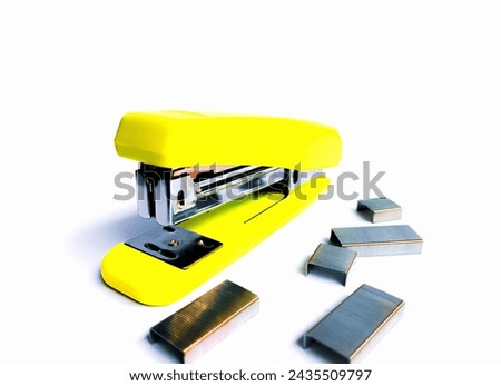 yellow stapler and row staples on white background. Office stock on the isolated background. 
