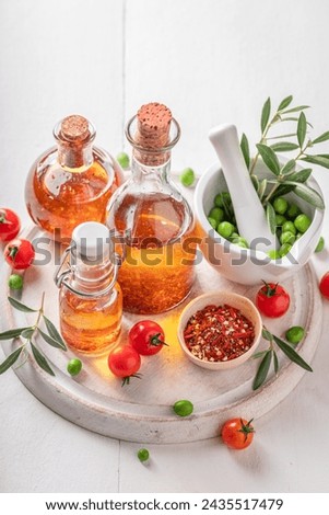 Fresh and healthy oil with dried aromatic tomatoes. Products made of olives and dried tomatoes. Royalty-Free Stock Photo #2435517479