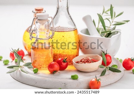 Fresh and healthy oil in bottle with dried tomatoes. Products made of olives and dried tomatoes. Royalty-Free Stock Photo #2435517489
