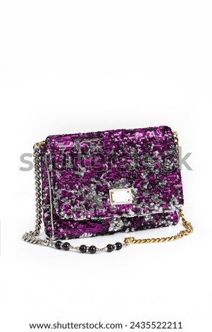 Small women's handbag, decorated with rhinestones, frontal arrangement, on a white background. Royalty-Free Stock Photo #2435522211