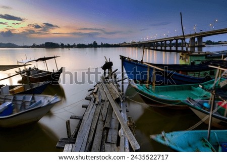 fisherman boat moored in port near the bridge , long exposure photography.