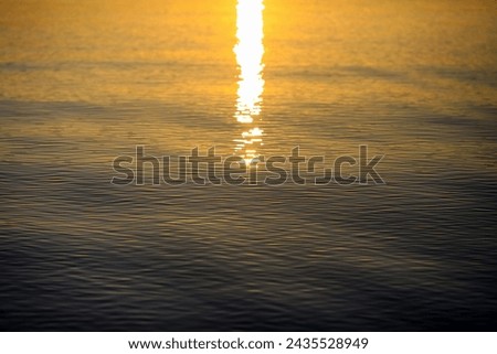 background with water  and sun rays during sunset