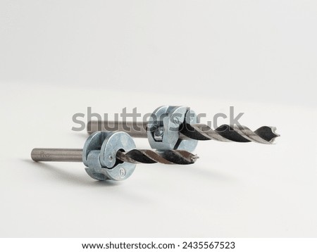 Woodworking steel drill bits with depth collars attached sizes six and eight isolated on a white background