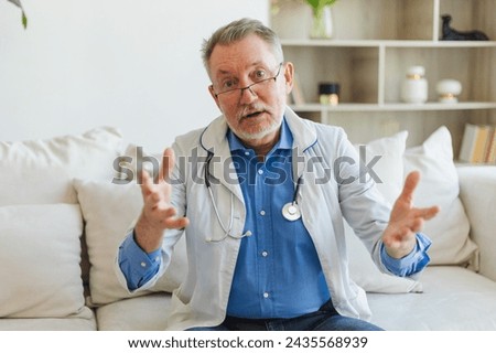 Senior man doctor talk on video call have consultation with patient look at camera webcam. Professional senior mature healthcare expert examining patient online. Healthcare concept. Webcamera view Royalty-Free Stock Photo #2435568939