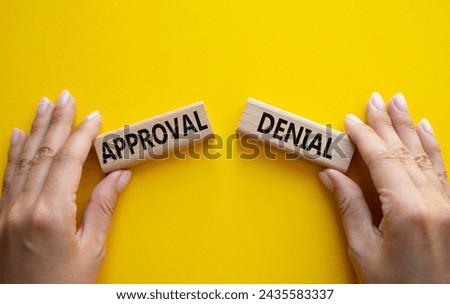 Approval or Denial symbol. Concept word Approval or Denial on wooden blocks. Businessman hand. Beautiful yellow background. Business and Approval or Denial concept. Copy space Royalty-Free Stock Photo #2435583337