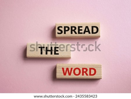 Spread the Word symbol. Concept words Spread the Word on wooden blocks. Beautiful pink background. Business and Spread the Word concept. Copy space.