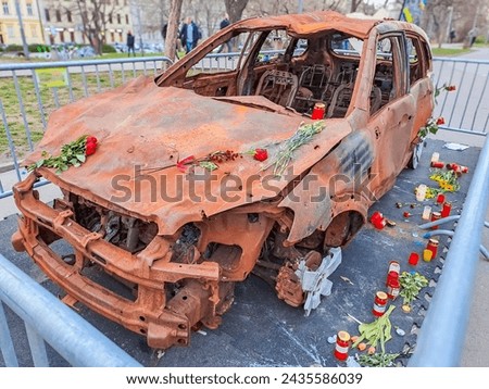 burned-out civilian car. War in Ukraine. Russian invasion of Ukraine. War crimes Royalty-Free Stock Photo #2435586039