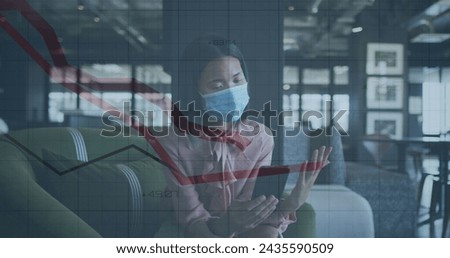 Image of financial data processing over businesswoman with face mask using smartphone in office. global business and digital interface during covid 19 pandemic concept digitally generated image.