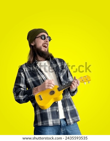 Ukulele Music Instrument Player. Modern Style Young Man Music Performance. Yellow Clean Background. Close-up Portrait. Cool Guy. Studio Photo. Acoustic Sound. Artist Standing. Advertisment Photography
