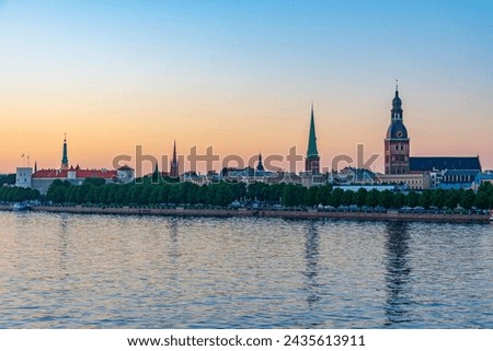 Sunset panorama of riga including the Riga castle, cathedral and saint James church, Latvia. . Royalty-Free Stock Photo #2435613911