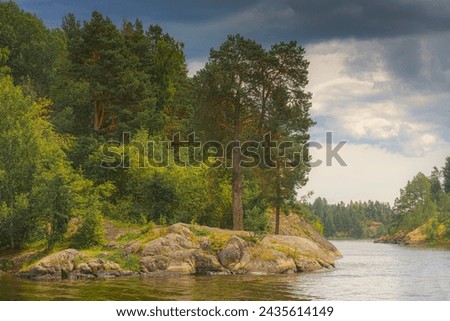 Republic of Karelia, Russia, Panoramic view of the wooded coast of Lake Ladoga, cloudy sky, daytime, virgin nature, taiga Royalty-Free Stock Photo #2435614149
