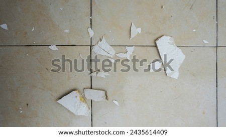 ceiling paint chips that fell on the ceramic floor Royalty-Free Stock Photo #2435614409