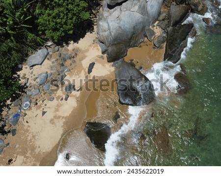 aerial photo taken with a drone of a blue water beach with clear sand and forest