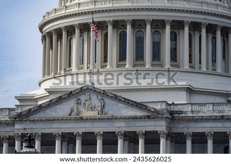 United States Capitol Building close-up with American Flag Flying Royalty-Free Stock Photo #2435626025