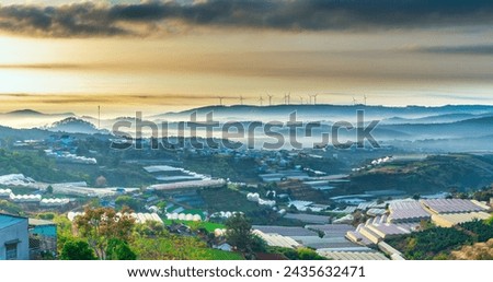 The morning landscape in the valley Da Lat, Vietnam with fog covered and sunrise background is so blurry, so beautiful and peaceful Royalty-Free Stock Photo #2435632471