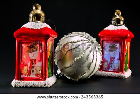 two vintage red lanterns with snowman and children picture and bright christmas ball