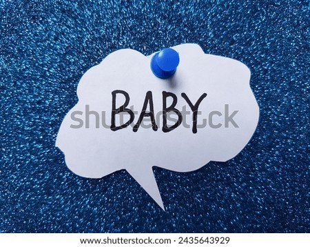 Baby writting on blue background.