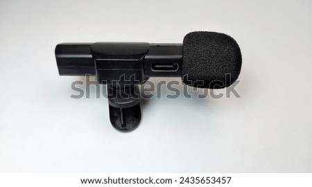 Black microphone isolated on white background. Close-up of microphone.