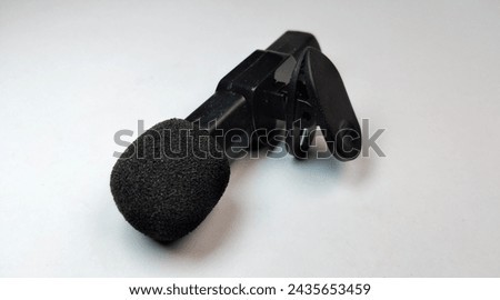 Black microphone isolated on white background. Close-up of microphone.