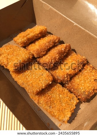A picture of crispy banana nugget with red velvet tiramisu topping