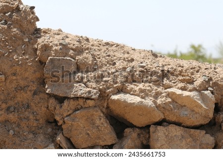 Timeless Elegance: Explore the rich textures of an old mud stone wall. A story etched in weathered details, a visual tapestry of history and character
 Royalty-Free Stock Photo #2435661753