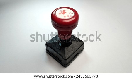 Red and black rubber stamp on a white background. Close-up.