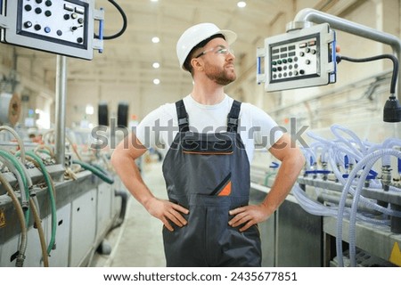 Portrait of factory worker. Young handsome factory worker.