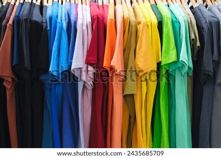 Multicolor family clothes on hangers in store, sale concept background, retail, marketing and merchandising concept background