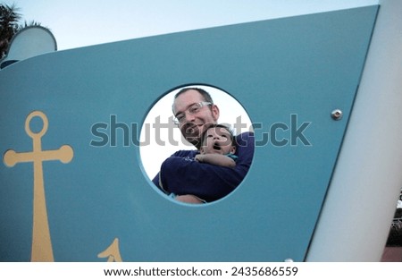 Hong Kong, Asia - 07 31 2010 : Exterior photo visual view of a proud father portrait dad daddy holding his newborn baby son cute kid child children babe and looking at camera 