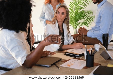 Company CEO listening coworkers proposals during coffee break at the modern coworking office. Royalty-Free Stock Photo #2435688569