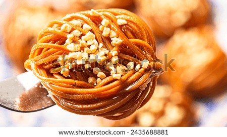 Experience the delightful blend of sweetness and nuttiness with Chebakia and Bouchnika. Royalty-Free Stock Photo #2435688881